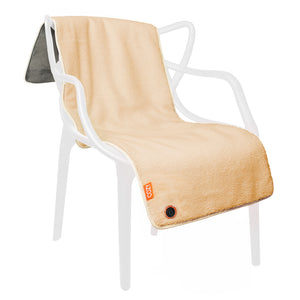 A COZY Heated Throw & Seat Cover Pad - JORV in beige, featuring a small power button and label in one corner, is draped over a modern white plastic chair; its underside is made of darker gray material.