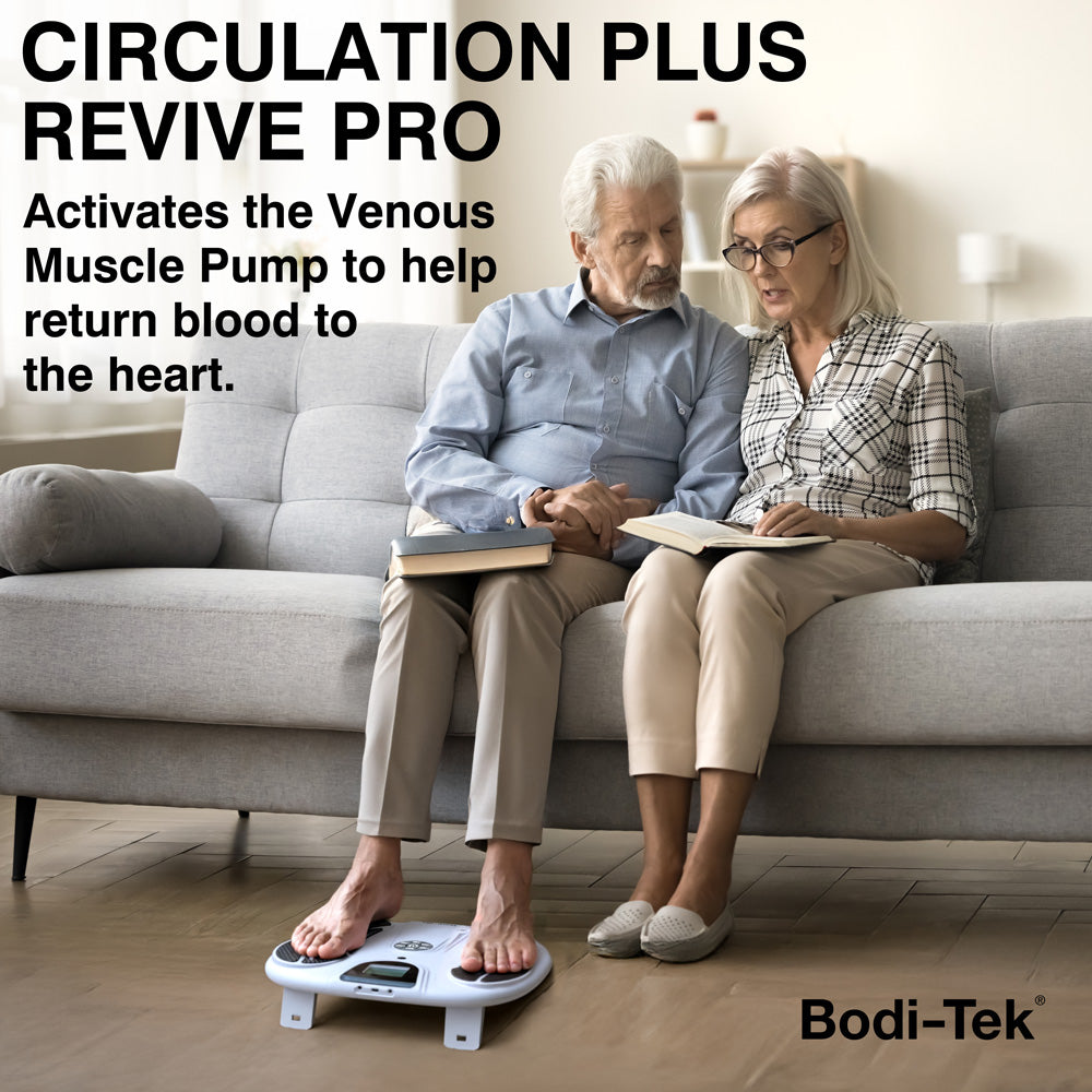 Elderly couple seated on sofa with husband using Bodi-Tek CIRCULATION PLUS REVIVE PRO