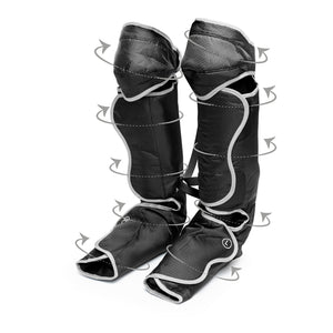 The Comfort360° Air Compression Half Leg Massager Boot in black features foot, calf, and thigh coverage. Shown upright with gray arrows indicating massage programs for lower leg therapy and white trim outlining the edges.