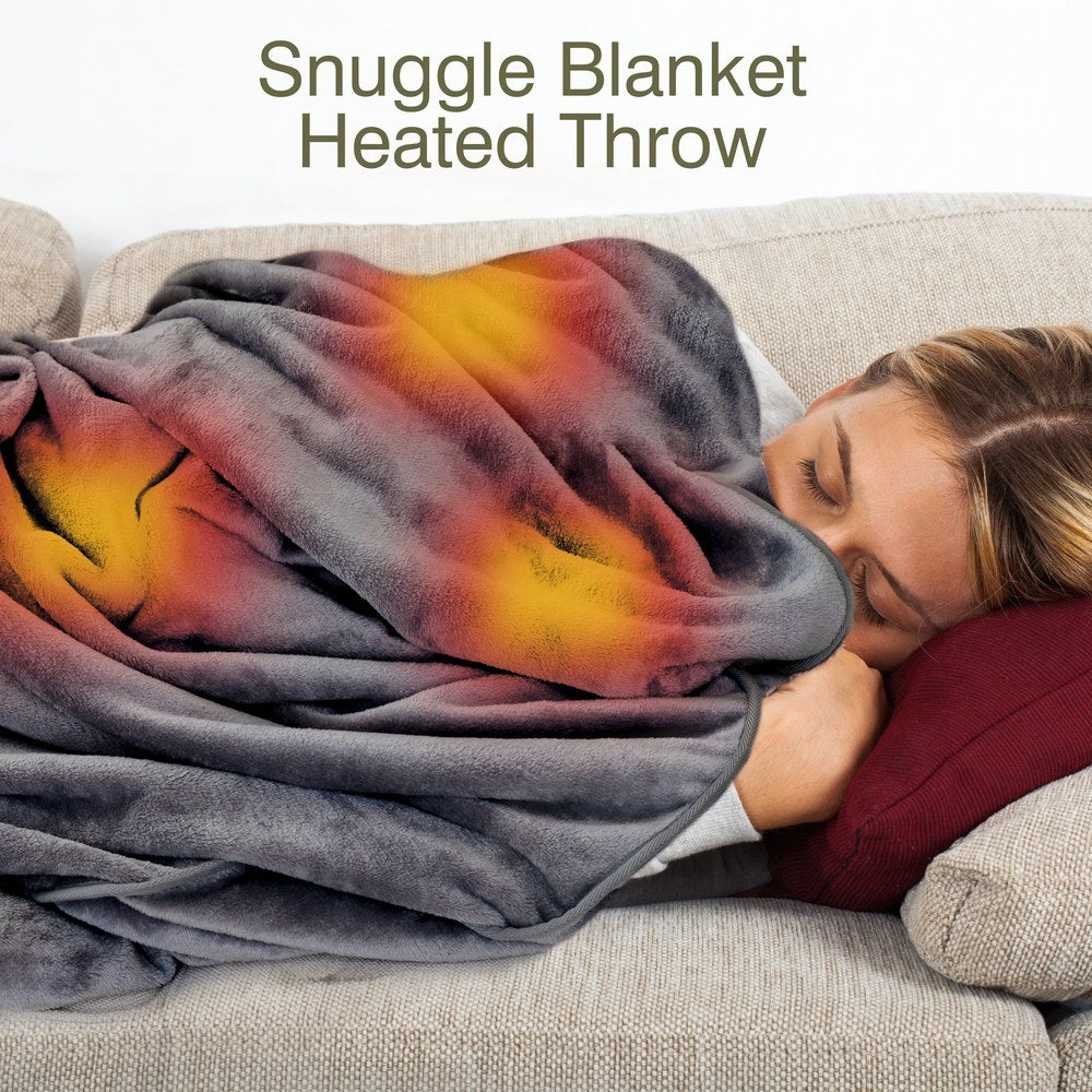 A woman relaxes on a couch with a Cozy Wireless Rechargeable Snuggle Blanket Heated Throw in warm yellow and red tones. "Snuggle Blanket Heated Throw" is displayed above her.