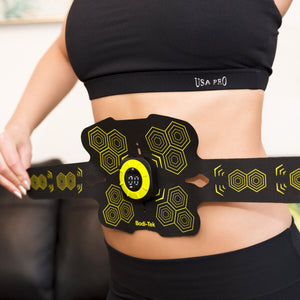 A person in a black sports bra uses the Abs and Oblique Trainer Pro, an abdominal toning belt with yellow hexagon patterns and a digital display, to target their core ab muscles.