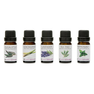 Five small amber bottles from the Rio Aromatherapy 100% Essential Oil Collection are lined up, labeled Eucalyptus, Lemongrass, Lavender, Tea Tree, and Peppermint, each featuring plant illustrations and black caps.