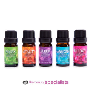 Five bottles of Rio Wellbeing Collection Aromatherapy Essential Oils—Relax, Vitality, Sleep, Harmony, and Energy—stand side by side with distinct colored labels. The beauty specialists logo appears below these premium oils.