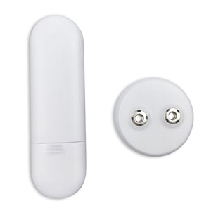 The Circulation Plus Boost & Revive Mat, a white oval electronic device with a removable cap and a round battery compartment showing two metal contacts, is displayed on a plain white background.