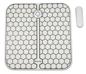 The Circulation Plus Boost & Revive Mat is a square electronic foot pad with a hexagonal grid, central M button, and four-button remote control—ideal as a portable leg exerciser and muscle stimulator.