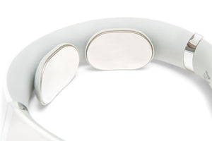 Close-up of the Neck & Shoulder Massager, showing its white design with two smooth, oval metal pads inside for skin contact and electrical muscle stimulation.