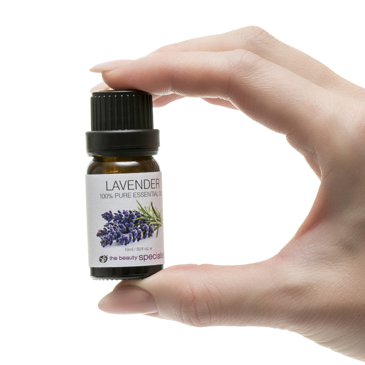 A hand holds a small brown bottle from the Rio Aromatherapy 100% Essential Oil Collection, labeled Lavender and featuring lavender sprigs, showcasing one of the finest aromatherapy oils against a white background.