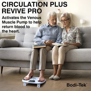 Elderly couple seated on sofa with husband using Bodi-Tek CIRCULATION PLUS REVIVE PRO