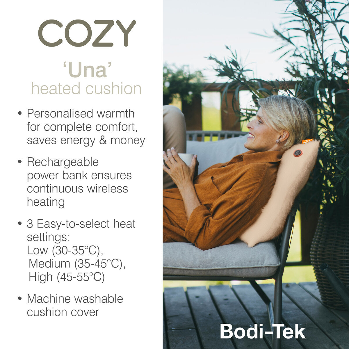 A smiling woman relaxes on an outdoor chair, leaning against a beige COZY Heated Cushion Cordless - UNA Knitted (45cm x 45cm), which features adjustable heat settings, a rechargeable battery, and a washable cover.
