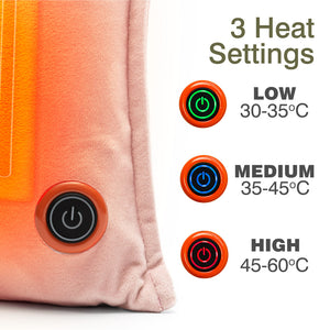 Close-up of the Cozy UNA Rechargeable Hot Water Bottle, a soft pink heated cushion with a power button. Text displays 3 heat settings: LOW (30-35°C, green), MEDIUM (35-45°C, blue), HIGH (45-60°C, red) and matching indicator lights.