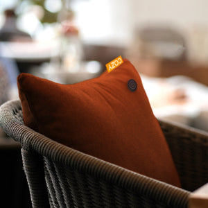 Orange heated cushion in an outdoor chair.