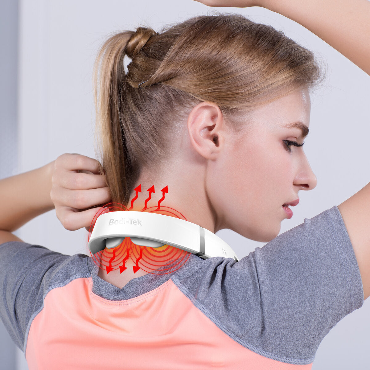 A woman uses the Neck & Shoulder Massager, with red lines showing heat and vibration on her neck to suggest muscle relief and pain treatment.