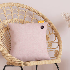 Pink heated cushion on wooden circular chair.