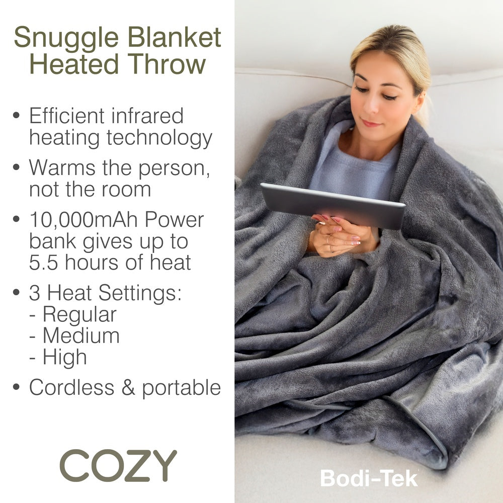A person uses a tablet while sitting on a gray Cozy Wireless Rechargeable Snuggle Blanket Heated Throw, displayed next to features including a 10,000mAh power bank and three heat settings.