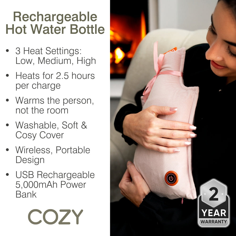 A person holds a pink Cozy UNA Rechargeable Hot Water Bottle with a power button, next to a list of product features including three heat settings and a 2-year warranty badge.