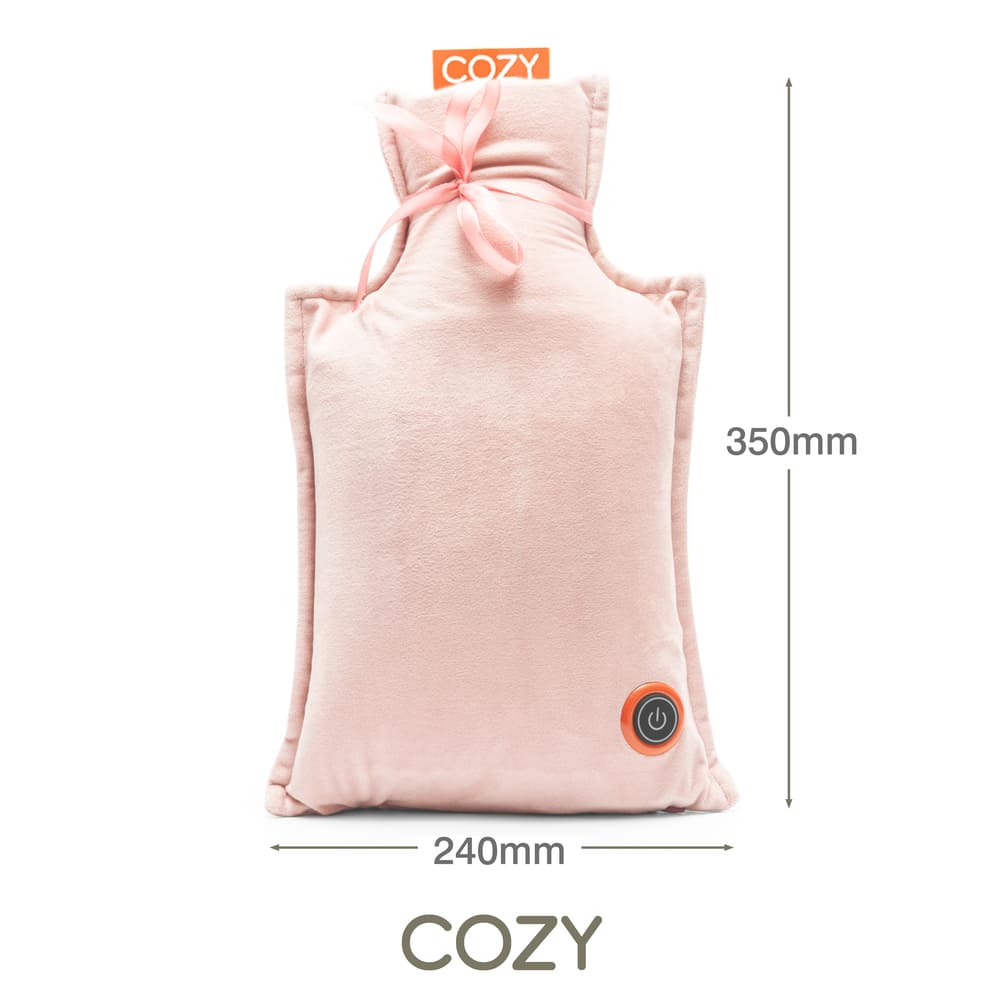 The Cozy UNA Rechargeable Hot Water Bottle is a rectangular pink pillow (240mm × 350mm) with a soft fabric, ribbon top, circular power button at the bottom right, and "COZY" printed above and below.
