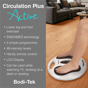 A person uses the Circulation Plus Active Lower Leg & Foot Exerciser (2025) on a wooden floor in a living room. Features include EMS/NMES technology, 99 intensity levels, remote control, and an LCD display for easy operation.
