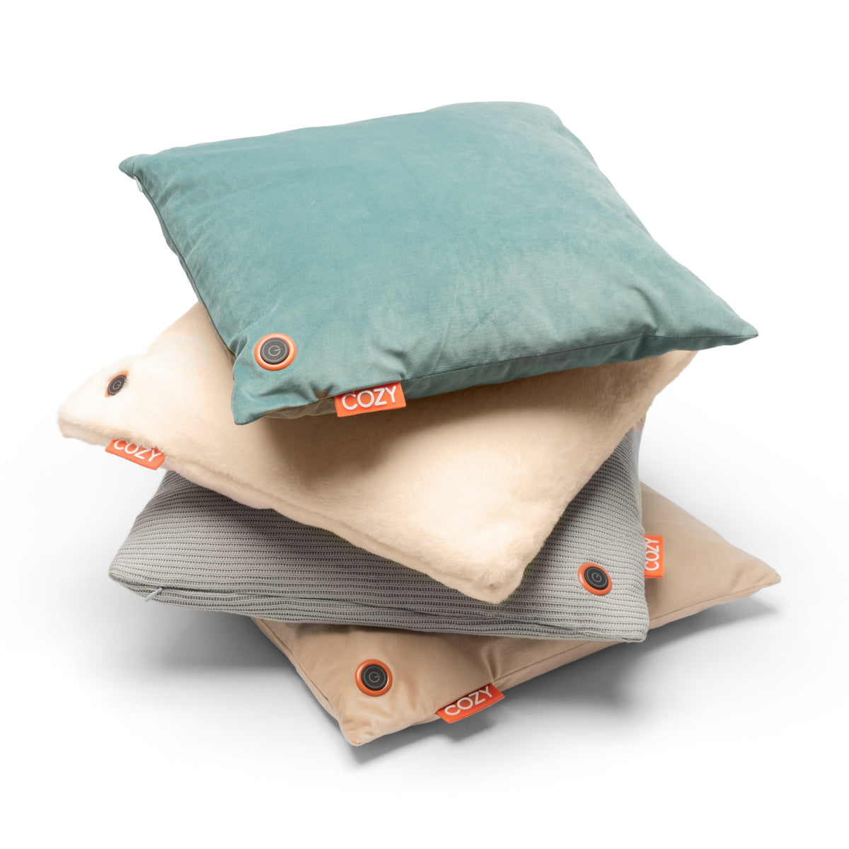 A stack of four square pillows in assorted colors and textures, each with an orange “COZY” tag and button accent—perfect for mixing style and comfort, especially with the COZY Heated Cushion Cordless - UNA Velvet (45cm x 45cm).