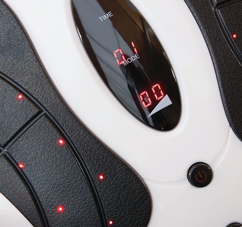 Close-up of the Circulation Plus Active Lower Leg & Foot Exerciser (2025) control panel, showing 01 and 00 on display, with textured black foot pads, red indicator lights, and a power button. This device promotes relaxation and lower leg exercise.
