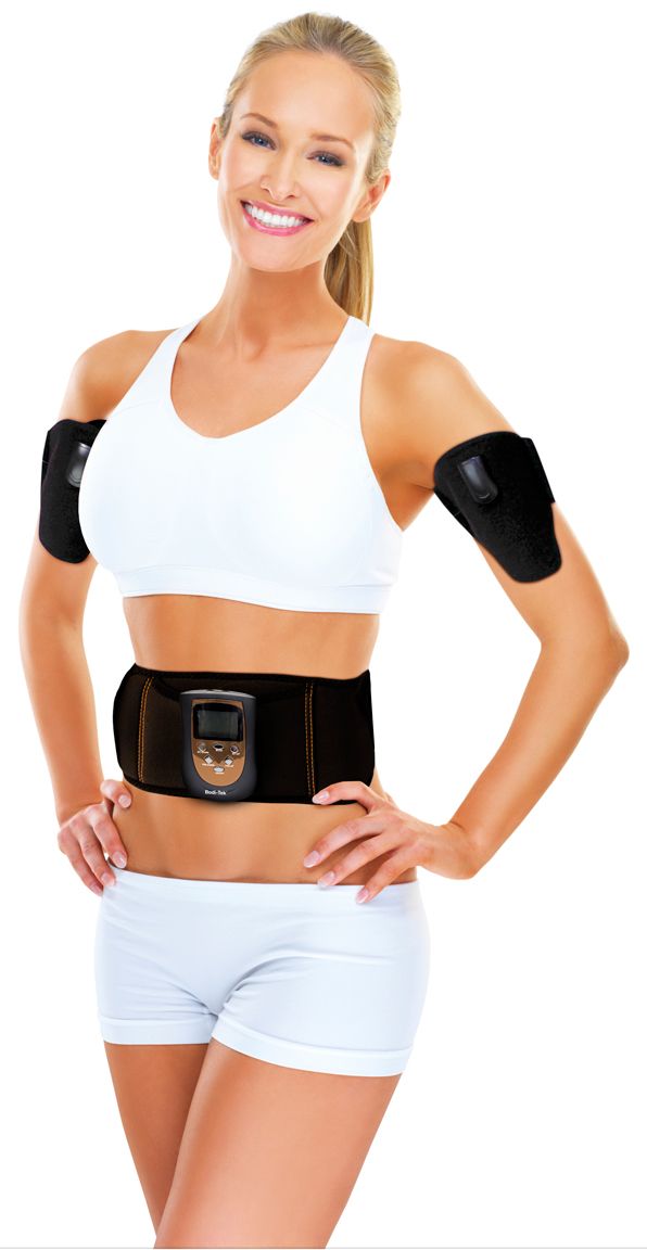 A smiling woman stands hands on hips against a white background, wearing the Ab & Arm Unisex Toning Belt on her upper arms and waist over a white sports bra and shorts.